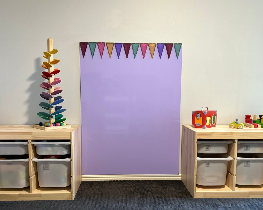 A gorgeous playroom with pretty whiteboard. The whiteboard is in fact a lovely purple colour.